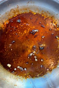 Fry garlic and add the glaze to the same pan