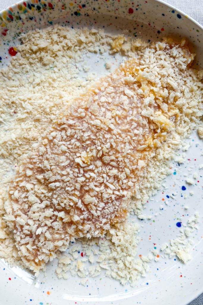 now press chicken into the panko
